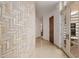 Bright hallway features a curved brick wall and marble floors leading to the outdoor area at 6620 E Stallion Rd, Paradise Valley, AZ 85253