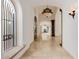 Long hallway with arched doorways, travertine floors and decorative lighting fixtures at 6620 E Stallion Rd, Paradise Valley, AZ 85253