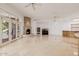Expansive living area featuring travertine floors, stone fireplace, and patio access at 6620 E Stallion Rd, Paradise Valley, AZ 85253