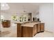 Bright living room with a fireplace, wet bar, tile floors, and large windows overlooking the backyard at 6620 E Stallion Rd, Paradise Valley, AZ 85253