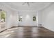 Bright, open living room with tray ceiling, ceiling fan, and beautiful wood flooring at 6620 E Stallion Rd, Paradise Valley, AZ 85253