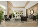 Grand living room featuring a stone fireplace, high ceilings, ample natural light, and neutral tones at 6620 E Stallion Rd, Paradise Valley, AZ 85253