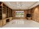 Cozy living room features built-in bookcase, a fireplace, and views of the outdoor greenery at 6620 E Stallion Rd, Paradise Valley, AZ 85253