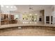 Spacious living room with granite countertops, tiled floors, fireplace, and backyard access at 6620 E Stallion Rd, Paradise Valley, AZ 85253