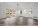 Bright, open living room with tray ceiling, ceiling fan, wood floors, and access to outdoor patio at 6620 E Stallion Rd, Paradise Valley, AZ 85253