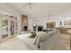 Bright living room with a fireplace, tile floors, ceiling fans, and a wet bar for entertaining guests at 6620 E Stallion Rd, Paradise Valley, AZ 85253