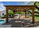 Charming gazebo provides shade and a view of the pool and landscaped backyard at 6620 E Stallion Rd, Paradise Valley, AZ 85253
