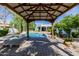 Inviting covered gazebo overlooking a sparkling pool and manicured grounds in a tranquil backyard oasis at 6620 E Stallion Rd, Paradise Valley, AZ 85253