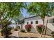 Landscaped side yard featuring a brick walkway, flowers, and mature trees enhancing the property's appeal at 6620 E Stallion Rd, Paradise Valley, AZ 85253