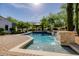 Beautiful swimming pool with stone waterfall feature and picturesque gazebo amidst mature trees at 6620 E Stallion Rd, Paradise Valley, AZ 85253