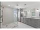 Bright bathroom featuring a glass-enclosed shower and double vanities with marble countertops at 1264 E Walnut Rd, Gilbert, AZ 85298