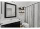 Well-lit bathroom with a modern vanity, decorative mirror, and shower-tub combination at 1264 E Walnut Rd, Gilbert, AZ 85298