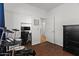 Clean bedroom with a dark dresser, hard wood floors, drum set, and ample closet space at 1264 E Walnut Rd, Gilbert, AZ 85298