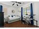 Cozy bedroom featuring a comfortable daybed, a ceiling fan, and a window providing natural light at 1264 E Walnut Rd, Gilbert, AZ 85298