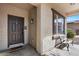 Charming front porch showcasing a cozy bench and a welcoming entrance with decorative door mat at 1264 E Walnut Rd, Gilbert, AZ 85298