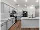 Modern kitchen featuring white cabinets, sleek appliances, and island with sink, perfect for culinary enthusiasts at 1264 E Walnut Rd, Gilbert, AZ 85298