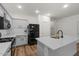 Well-lit kitchen with white cabinets, stainless steel appliances, and a functional island at 1264 E Walnut Rd, Gilbert, AZ 85298