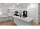Stylish kitchen boasting white cabinets, modern appliances, and an island, perfect for cooking and gathering at 1264 E Walnut Rd, Gilbert, AZ 85298