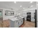 Modern kitchen featuring sleek white cabinetry, stainless steel appliances, and a center island with sink at 1264 E Walnut Rd, Gilbert, AZ 85298