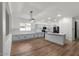 Bright kitchen showcasing white cabinetry, island with sink, and stainless-steel appliances for a modern feel at 1264 E Walnut Rd, Gilbert, AZ 85298