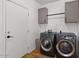 Functional laundry room with a washer, dryer, and cabinets providing ample space for laundry and storage at 1264 E Walnut Rd, Gilbert, AZ 85298