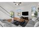 Bright, open-concept living room with high ceilings, wood floors, and neutral-toned furnishings at 1264 E Walnut Rd, Gilbert, AZ 85298