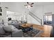 Open-concept living room flows into kitchen with hardwood floors and a cozy seating area at 1264 E Walnut Rd, Gilbert, AZ 85298