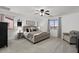 Cozy main bedroom with soft carpet, ceiling fan, and large windows at 1264 E Walnut Rd, Gilbert, AZ 85298
