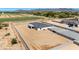 Aerial shot of a contemporary home showcasing a green lawn and xeriscaping within a block-fenced yard at 18083 W Amber Dr, Goodyear, AZ 85338