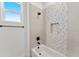 This bathroom features modern tile in the shower/tub combo with sleek black hardware at 18083 W Amber Dr, Goodyear, AZ 85338