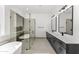 This gorgeous bathroom features a glass shower enclosure, and dual sink vanity with quartz counters at 18083 W Amber Dr, Goodyear, AZ 85338