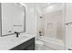 Modern bathroom featuring a shower over tub with decorative tiles and black hardware at 18083 W Amber Dr, Goodyear, AZ 85338
