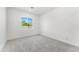 This bright bedroom offers plush carpet and a large window at 18083 W Amber Dr, Goodyear, AZ 85338