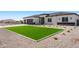 Inviting single-story home with a lush green lawn and desert landscaping at 18083 W Amber Dr, Goodyear, AZ 85338
