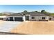 Modern home showcasing a three-car garage and sleek front entrance, complemented by a freshly poured driveway at 18083 W Amber Dr, Goodyear, AZ 85338