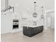 Modern kitchen features white cabinets, stainless steel appliances, and an island with black cabinets at 18083 W Amber Dr, Goodyear, AZ 85338