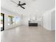Open-concept living area with tile floors, a modern ceiling fan, and an open kitchen area at 18083 W Amber Dr, Goodyear, AZ 85338