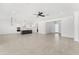 Spacious open-concept living area featuring modern fixtures, tile flooring, and a large kitchen island at 18083 W Amber Dr, Goodyear, AZ 85338
