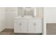 Dual vanity with white cabinets and tile flooring at 3409 E Alexander Dr, San Tan Valley, AZ 85143