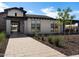 Well-maintained home exterior with stone accents, desert landscaping, and a welcoming entryway at 3409 E Alexander Dr, San Tan Valley, AZ 85143