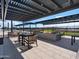 Outdoor seating area with a fire pit and comfortable lounge chairs under a modern shade structure at 3409 E Alexander Dr, San Tan Valley, AZ 85143
