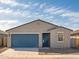 Charming single-story home featuring a blue garage door, desert landscaping, and a welcoming entryway at 3409 E Alexander Dr, San Tan Valley, AZ 85143