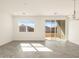Bright living area with tiled floors, large windows, and sliding glass doors at 3409 E Alexander Dr, San Tan Valley, AZ 85143