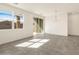 Living area with large window, sliding glass door, and modern lighting fixture at 3409 E Alexander Dr, San Tan Valley, AZ 85143