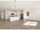 Open living space featuring a kitchen island, modern lighting, and stainless-steel appliances at 3409 E Alexander Dr, San Tan Valley, AZ 85143