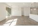 Spacious living area with tile flooring, sliding doors, and pendant lights at 3409 E Alexander Dr, San Tan Valley, AZ 85143