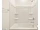 Close-up of a bright shower-tub combo with sleek fixtures and ample shelving at 3409 E Alexander Dr, San Tan Valley, AZ 85143