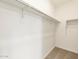 Bright walk-in closet featuring ample storage space and a neutral color scheme at 3409 E Alexander Dr, San Tan Valley, AZ 85143