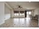 Bright living room features neutral colors, tile floors, large windows, and a ceiling fan at 20447 N 266Th Ave, Buckeye, AZ 85396