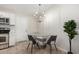 Small dining area with glass table and four chairs at 3646 N 69Th Ave # 60, Phoenix, AZ 85033